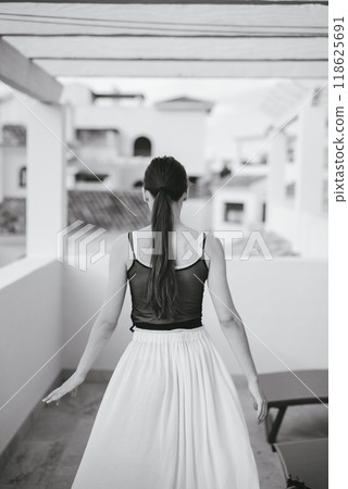 Embracing Elegance in Motion A Graceful Woman Captured in Stunning Monochrome Colors 118625691