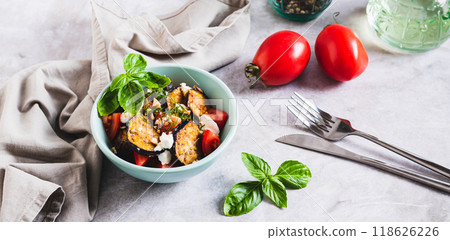 Appetizing salad of fried eggplant, tomatoes and ricotta in a bowl on the table web banner Appetizing salad of fried eggplant, tomatoes and ricotta in a bowl on the table web banner 118626226