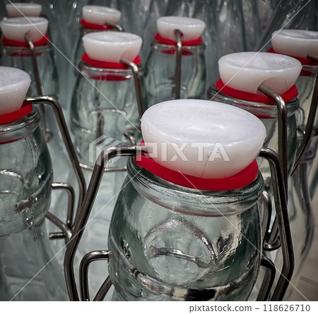 Glass bottles with rubber seals lined up on display for a market stall Glass bottles with rubber seals lined up on display for a market stall 118626710