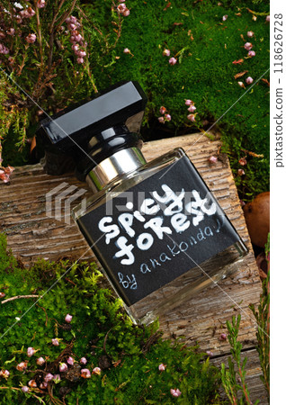 perfume bottles around green moss, heather flowers and leaves . close up. perfumery concept perfume bottles around green moss, heather flowers and leaves . close up. perfumery concept 118626728