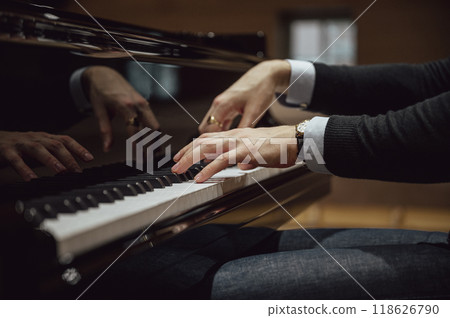 Low angle view of hands of a pianist playing pian Low angle view of hands of a pianist playing pian 118626790
