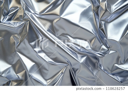 Wrinkled metallic silver surface with glossy reflections. 118628257