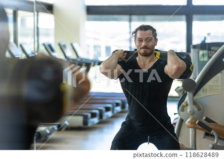 muscular man is exercising and lifting weights muscular man is exercising and lifting weights 118628489