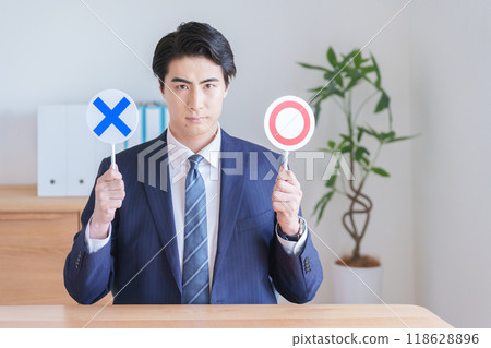 Businessman holding a rounded sign Businessman holding a rounded sign 118628896