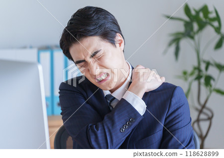 Businessman with stiff shoulders Businessman with stiff shoulders 118628899