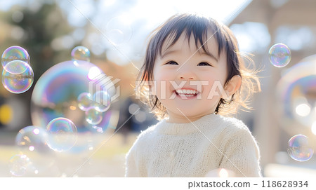 Cute smiling child with soap bubbles 118628934