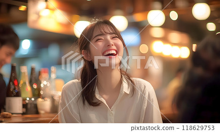 Young woman laughing in a bright izakaya restaurant Young woman laughing in a bright izakaya restaurant 118629753