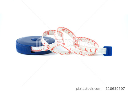 Flexible measuring tape coiled beside a blue plastic case isolated on a white background Flexible measuring tape coiled beside a blue plastic case isolated on a white background 118630307