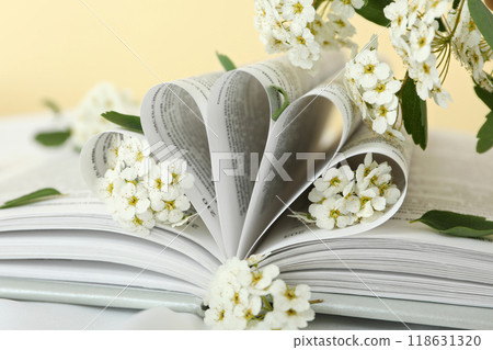 Aesthetics of books with flowers on a light background. 118631320