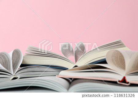 Books with wrapped pages on a pink background. Books with wrapped pages on a pink background. 118631326