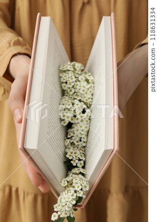 Aesthetics of books with flowers on a light background. Aesthetics of books with flowers on a light background. 118631334