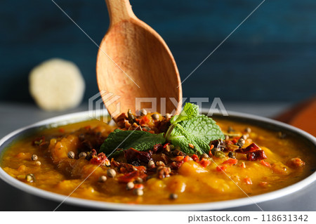 Sweet potato puree with spices in bowl and spoon on wooden background, close up Sweet potato puree with spices in bowl and spoon on wooden background, close up 118631342