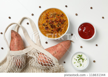 Mashed sweet potatoes in bowl, sauces and sweet potatoes in string bag on white background, top view Mashed sweet potatoes in bowl, sauces and sweet potatoes in string bag on white background, top view 118631344