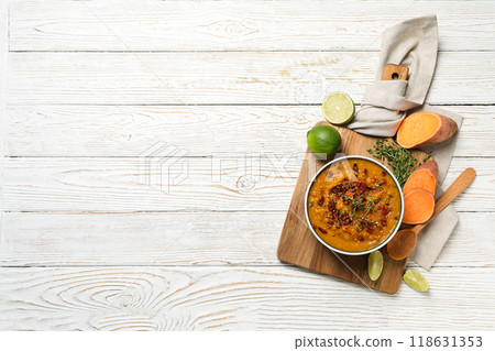 Sweet potato puree in bowl and ingredients on kitchen board on wooden background, space for text Sweet potato puree in bowl and ingredients on kitchen board on wooden background, space for text 118631353
