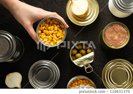 Cans with food, on a dark background. 118631370