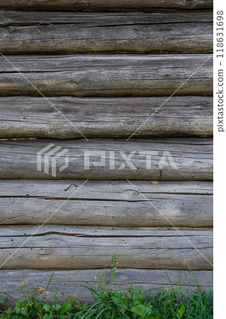 The wall of a wooden hut in the village. Logs background 118631698