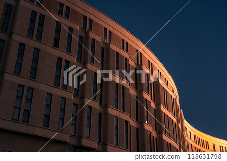 The business building in the form of a wave is illuminated late at night The business building in the form of a wave is illuminated late at night 118631798