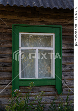 Green, wooden window of an Old Slavic house in the village 118631809