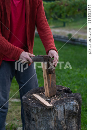 The man chopped wood for the fire. An evening in the village 118631865