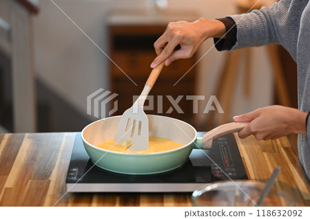 Cropped shot of young woman making simple scrambled egg for breakfast 118632092
