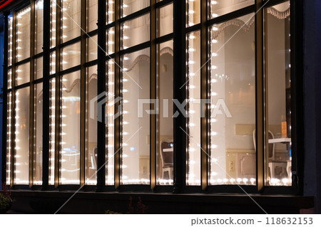The shop window is illuminated at night in the city of Minsk The shop window is illuminated at night in the city of Minsk 118632153