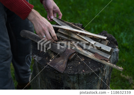 The man chopped wood for the fire. An evening in the village 118632339