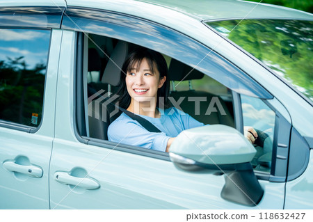 A woman driving a car A woman going for a drive A woman driving a car A woman going for a drive 118632427