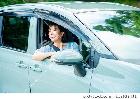 A woman driving a car A woman going for a drive A woman driving a car A woman going for a drive 118632431