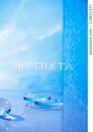 The skincare advertisement template features a product display area with two circular glass platforms, a lake, frosted panels, and a glass sphere against a light blue backdrop. The skincare advertisement template features a product display area with two circular glass platforms, a lake, frosted panels, and a glass sphere against a light blue backdrop. 118632472