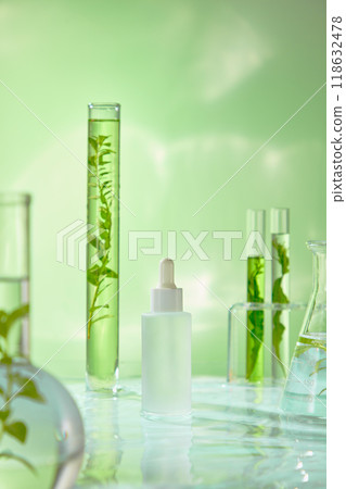 The perfect light blue backdrop to display beauty products features white serum droppers standing on water, surrounded by solution containers and fresh plant branches. The perfect light blue backdrop to display beauty products features white serum droppers standing on water, surrounded by solution containers and fresh plant branches. 118632478