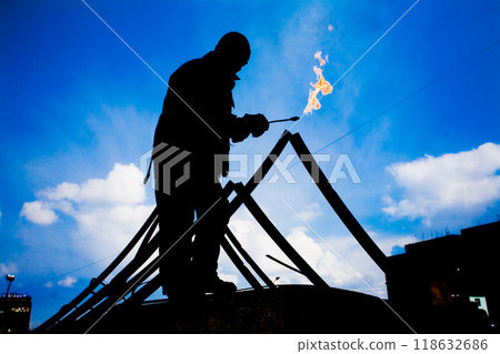 Welder in mask welding metal construction on open air. 118632686