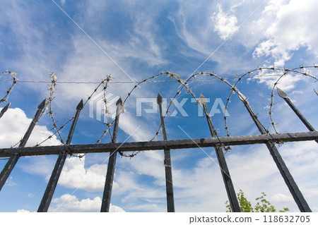 the barbed wire fence of protected prison territory 118632705