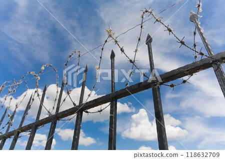 the barbed wire fence of protected prison territory 118632709