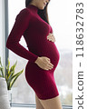 Pregnancy. Pregnant woman profile holding her belly in red dress. Beautiful model for pregnancy maternity clothes. 118632783