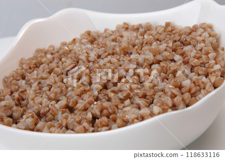 groats in plate on white 118633116