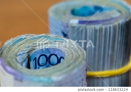 Thick wad of money cash on table Thick wad of money cash on table 118633224