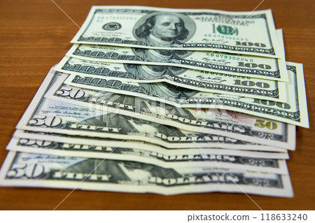 Thick wad of money cash on table Thick wad of money cash on table 118633240