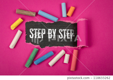 Step by step. Text under torn purple paper on a blackboard 118633262