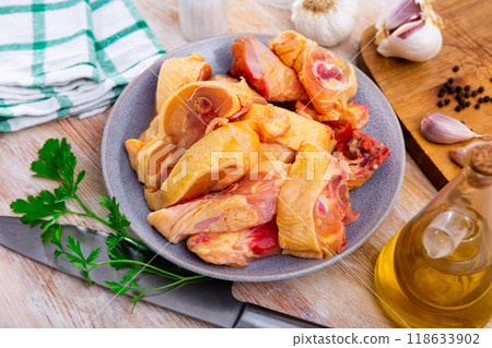 Uncooked chicken and condiments on kitchen table Uncooked chicken and condiments on kitchen table 118633902