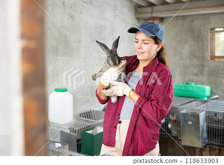 young european worker holding rabbit 118633903