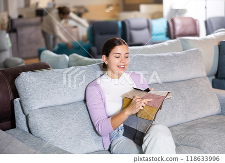 girl on the sofa infurniture store decides what fabric to choose girl on the sofa infurniture store decides what fabric to choose 118633996
