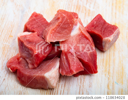 Raw pork neck meat cuts, top view on wooden background 118634028