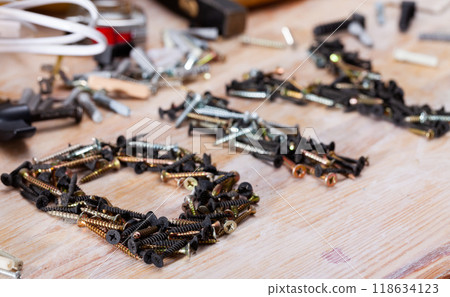 Word DIY lined with screws among fasteners and hand tools 118634123