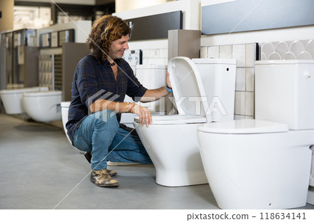Confident man picking out new toilet in hardware store 118634141