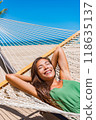 Beach vacation travel woman happy sleeping in hammock at holiday resort - Caribbean travel holidays Asian girl lying down relaxing outdoors sunbathing. 118635137
