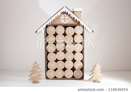 handmade advent calendar craft made of empty toilet paper rolls, DIY, step 4, top view, blue background, 118636054