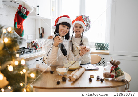 Mother and daughter baking cookies together for Christmas 118636388