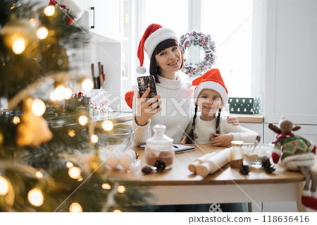 Mother and daughter baking together during Christmas holidays 118636416