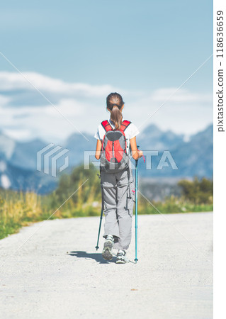 Lonely girl walks on mountain road Lonely girl walks on mountain road 118636659