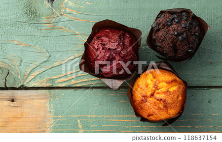 Mix of muffins ( cupcake ) chocolate , vanilla , berries . Top view 118637154